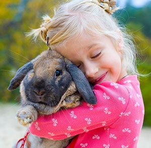 Little girl hugging her bunny