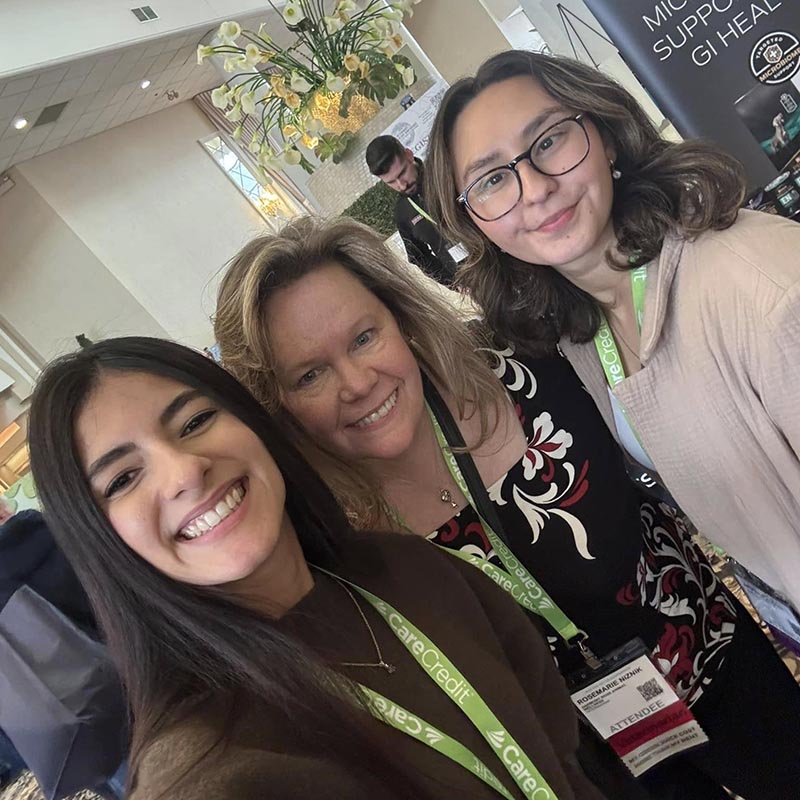 three girls taking a selfie at an event